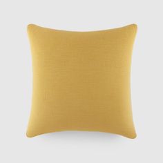 a yellow pillow on a white background