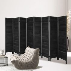 the room divider is made out of black wood