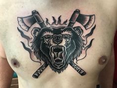 a man with a bear and two crossed axes on his chest is wearing a tattoo