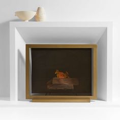 an empty fireplace with a vase on top