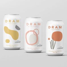 three cans of dram energy drink on a grey background