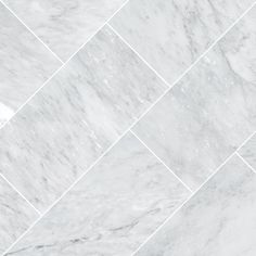 a white marble tile wall that looks like hexagonal tiles