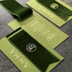 two green envelopes with the words wh and wh on them are sitting on top of each other