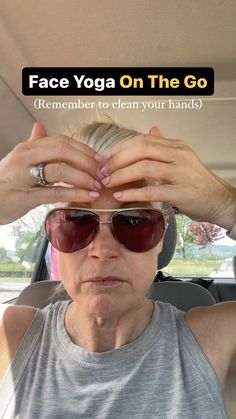 an older woman is sitting in the back seat of a car with her hands on top of her head