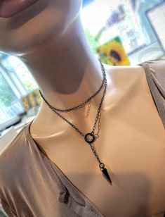 This is a dainty minimalist blackened steel Lariat Necklace Set wrap choker with Spike pendant.  The minimalist design gives it a trendy and stylish feel, while the black steel gives it a touch of gothic Punk edge. This necklace is versatile and can be worn long or doubled up for a layered look. This is a dainty chain, but is strong steel. is you are looking for someone more suitable to "fun and games" please take a look in my shop for more sturdy versions 😉 Approximately 35" or 39" measured en Punk Style Jewelry With Adjustable Chain For Gifts, Edgy Handmade Jewelry Gift, Handmade Edgy Jewelry For Gifts, Edgy Chain Jewelry For Gifts, Edgy Chain Jewelry As Gift, Edgy Chain Jewelry Gift, Edgy Chain Jewelry For Gift, Punk Style Necklace With Adjustable Chain For Gift, Edgy Choker With Adjustable Chain As Gift