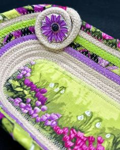 a close up of a bag with flowers on it and a flower in the center