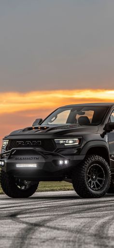 a black truck is parked on the road