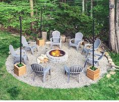 an outdoor fire pit with chairs around it