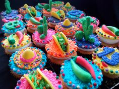 cupcakes decorated with colorful frosting and decorations