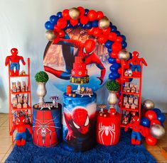 a spiderman birthday party with balloons and decorations