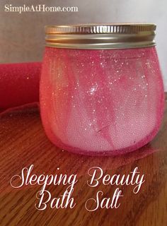 a jar filled with pink liquid sitting on top of a wooden table