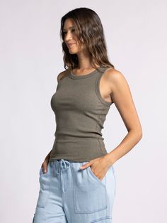 Style Description: Forever timeless in the EDLIN TANK! Crafted in a soft ribbed fabrication, this tank is a wear-everywhere kind of essential. Sleeveless tank Crew neckline Measurements for a size small: Length: 23" Chest: 14" Waist: 13" Fabric Content/Care: 48% Cotton 48% Modal 4% Spandex Machine Wash ColdImport Casual Solid Seamless Tank Top, Casual Seamless Solid Tank Top, Casual Green Stretch Tank Top, Casual Seamless Solid Color Tank Top, Basic Green Tank Top, Everyday Ribbed Tank Top, Fitted Olive Sleeveless Top, Fitted Sleeveless Olive Top, Green Casual Cami Tank Top