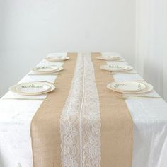 the table is set with plates and place settings for four people to sit down at