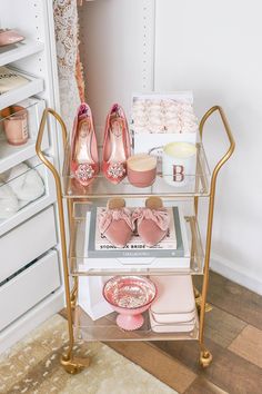 a three tiered cart with pink shoes on it