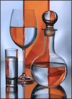 two wine glasses and a decanter on a reflective surface