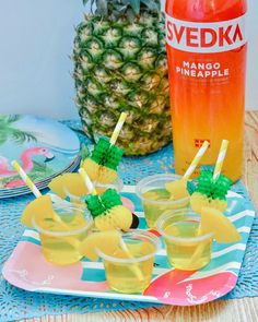 pineapple drinks and fruit on a table