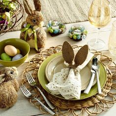 an easter table setting with bunny napkins and place settings