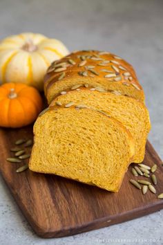 slices of bread on a cutting board with pumpkins in the background