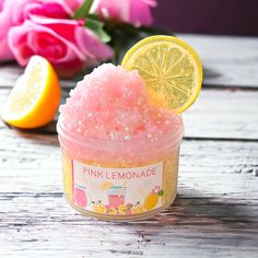 a pink lemonade bath soak sitting on top of a wooden table