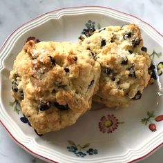 two cookies are sitting on a floral plate