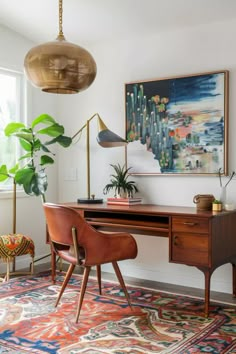 a room with a desk, chair and potted plants on the table in it