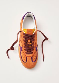 Orange suede sneakers with contrast details Coming in the brightest colors, the Tb.490 sneaker is made from orange suede with purple contrast details. Designed in a low-top silhouette sitting on rubber soles, it’s complete with classic features, including exposed stitching and logo stamps. Orange Details, Orange Trainers, Orange Sneakers, Finnish Fashion, Colorful Sneakers, Weekender Tote Bag, Orange Shoes, Sustainable Leather, Vegan Boots