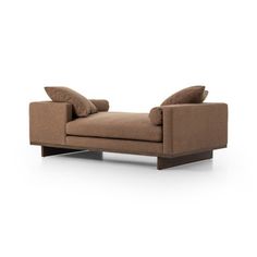 a brown couch with pillows on it