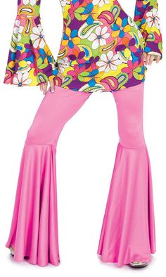 a woman in a colorful top and pink pants