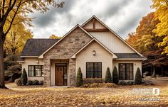 a house in the fall with autumn leaves on the ground and trees around it,