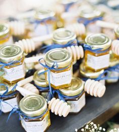 several honey jars with blue ribbons tied around them