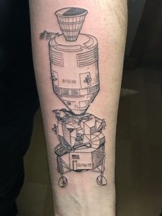 a black and white drawing of a coffee grinder tattoo on the right leg,