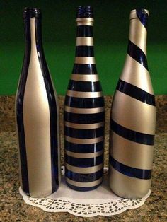 three vases sitting on top of a counter next to each other