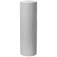 a white vase sitting on top of a table