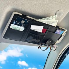 a wallet with money and glasses hanging from it