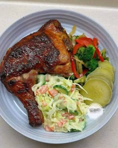 a white plate topped with meat and veggies