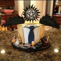 a cake decorated with an image of a tie and wings on top of a kitchen counter