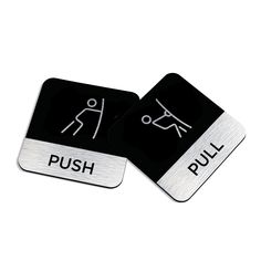 two black and white square coasters with the words push and pull printed on them