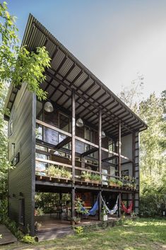 the house is made out of metal and has hammocks hanging from it's roof