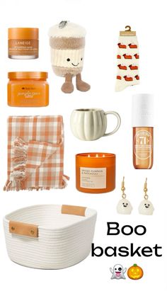 an assortment of items that include pumpkins, candles, and other things to put in the basket