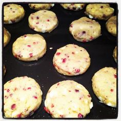 cookies with cranberry toppings cooking in a pan