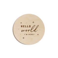 a wooden coaster that says hello world i'm here