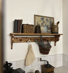 a shelf with books, baskets and other items on it in a kitchen area next to a stove