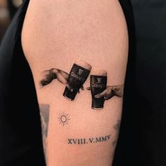 a person with a tattoo on their arm holding two mugs and the words evil v myv