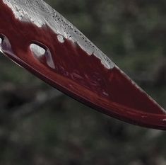 a red knife with white spots on it