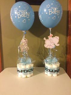 two baby shower items with balloons on top