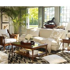 a living room filled with lots of white furniture