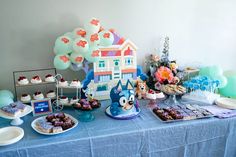 a blue table topped with lots of desserts