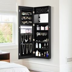 a black jewelry cabinet with lots of necklaces