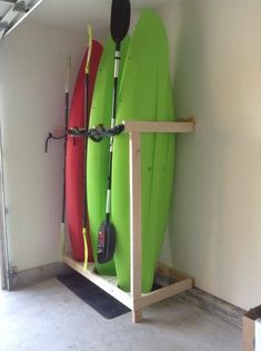 two surfboards are mounted to the wall with hooks