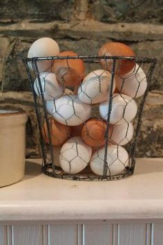 a basket filled with eggs sitting on top of a counter